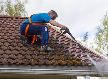 man cleaning roof