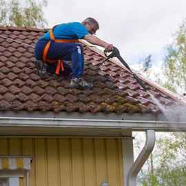 man cleaning roof
